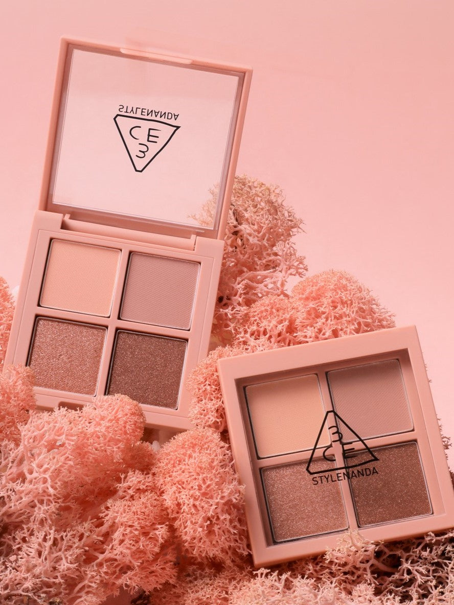 Two 3CE Mini Multi Eye Color Palette eyeshadows displayed on pink coral background, showcasing neutral and shimmering shades.