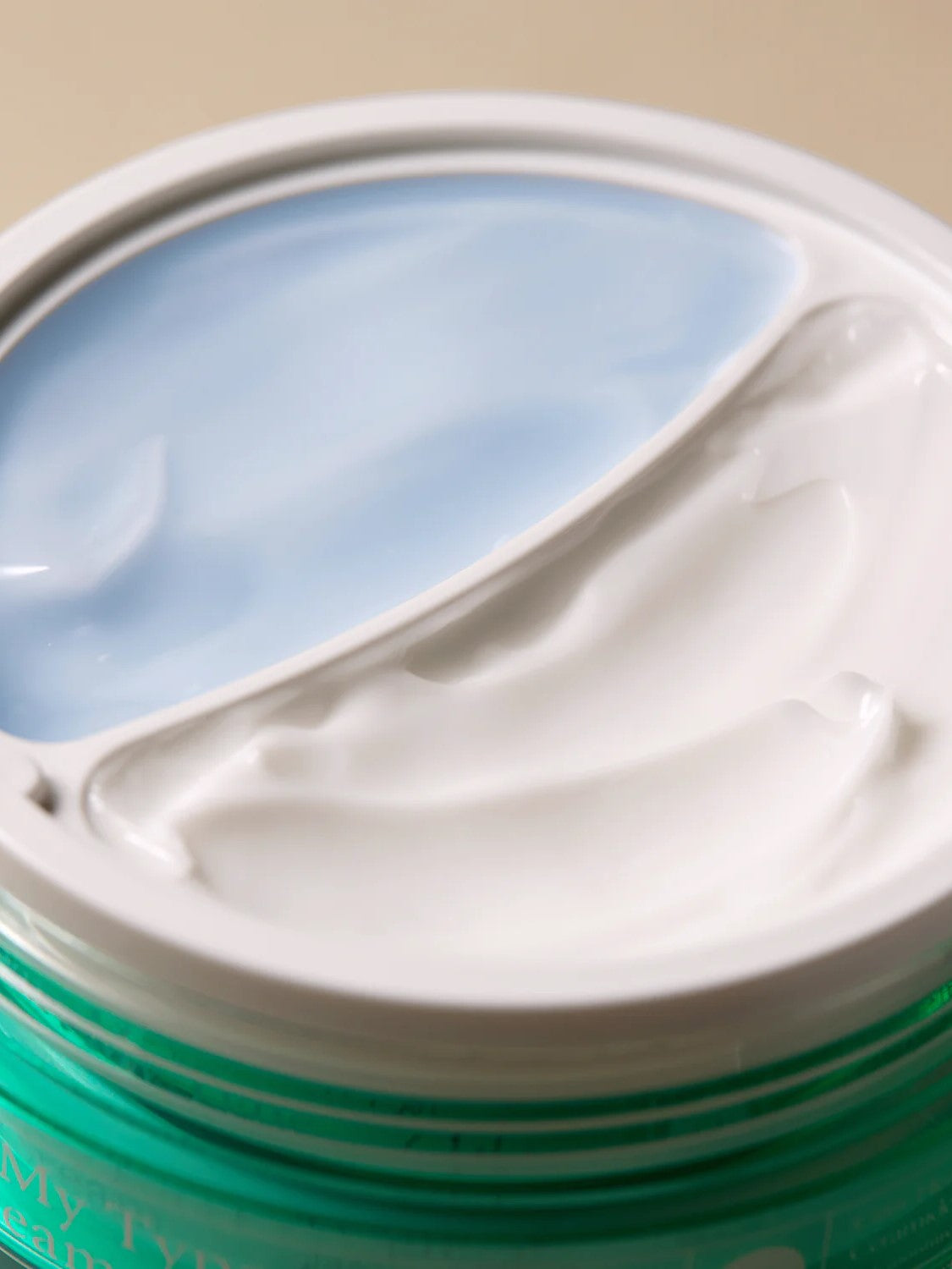 Close-up of Axis-Y Cera-Heart My Type Duo Cream texture, showing two sections: light blue gel on the left and thick white cream on the right.