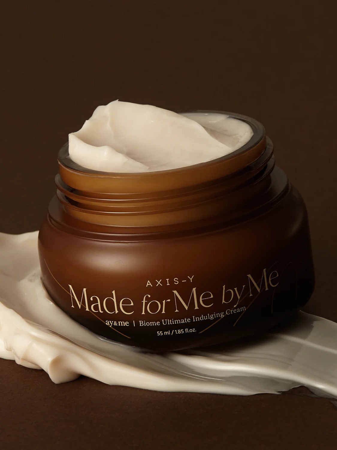 AXIS-Y 'Made for Me by Me' Biome Ultimate Indulging Cream with creamy texture, placed on a dark smooth surface.