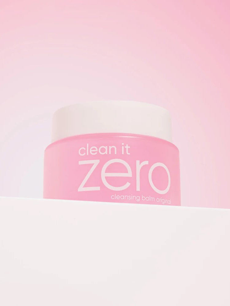 Banila Co Clean It Zero Cleansing Balm Original in a pink jar with a white lid, displayed on a gradient pink background.