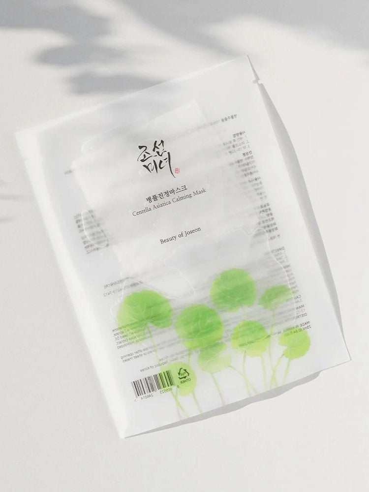 A pack of Centella Asiatica Calming Mask by Beauty of Joseon, featuring a minimalist design with Centella plant illustrations, highlighting its soothing benefits.