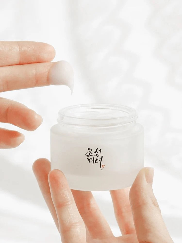 Close-up of Beauty of Joseon Dynasty Cream, with a finger scooping its smooth, rich texture.