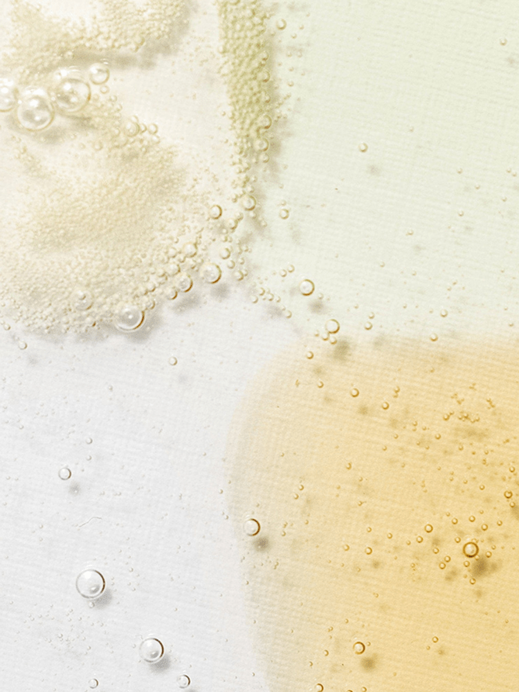 Close-up of bubbles in various shades floating on a white surface, showcasing the different textures of the Beauty of Joseon Serum collection.