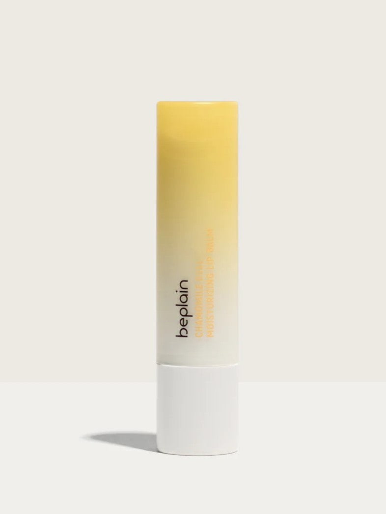 A tube of Beplain Chamomile Intense Moisturizing Lip Balm with a gradient yellow design, set against a neutral background.
