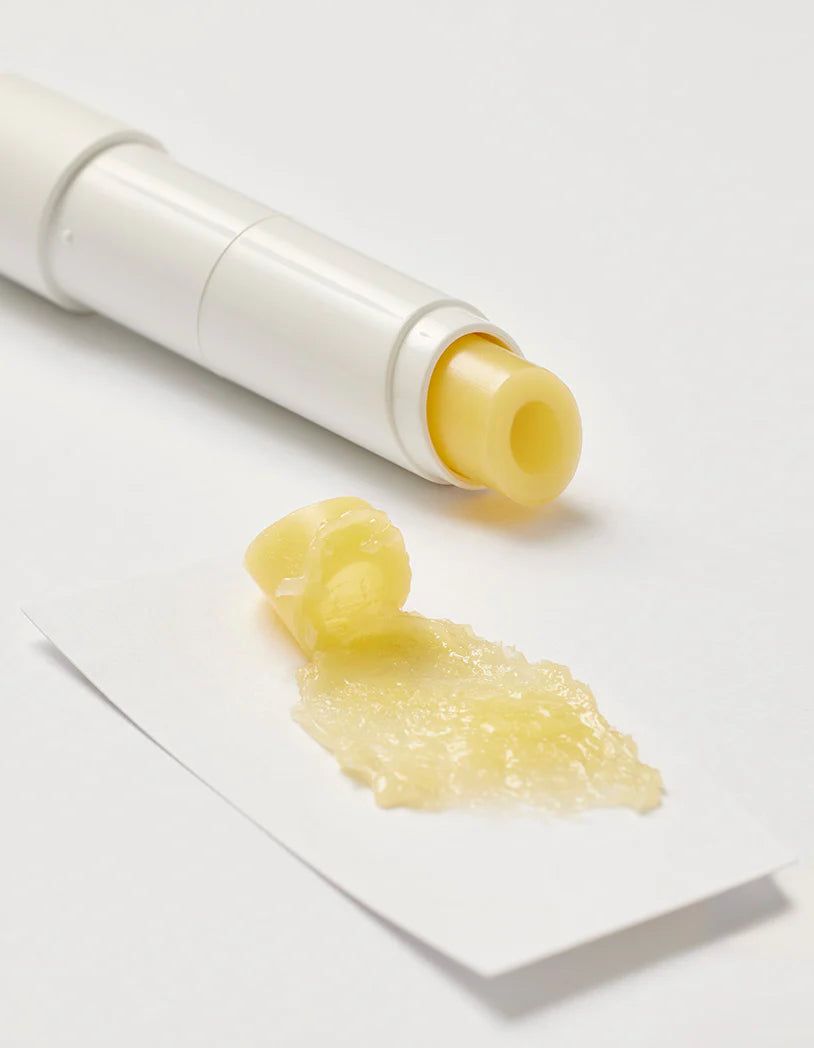 Beplain Chamomile Intense Moisturizing Lip Balm with a glossy yellow swatch spread beside the tube on a white surface.