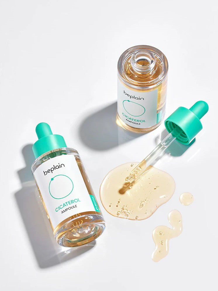Two Beplain Cicaterol Ampoule bottles, with one dropper releasing amber serum surrounded by serum drops on a white surface.