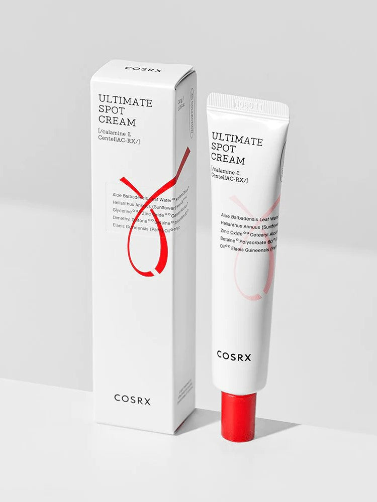 Cosrx Ultimate Spot Cream in a sleek tube with red accents and packaging, designed for soothing skin and targeting blemishes.