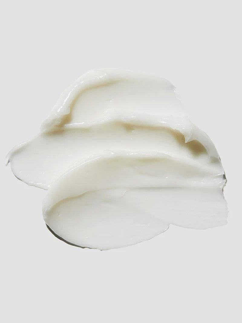 Close-up of the creamy texture of Cosrx Ceramide Cream on a light gray background.