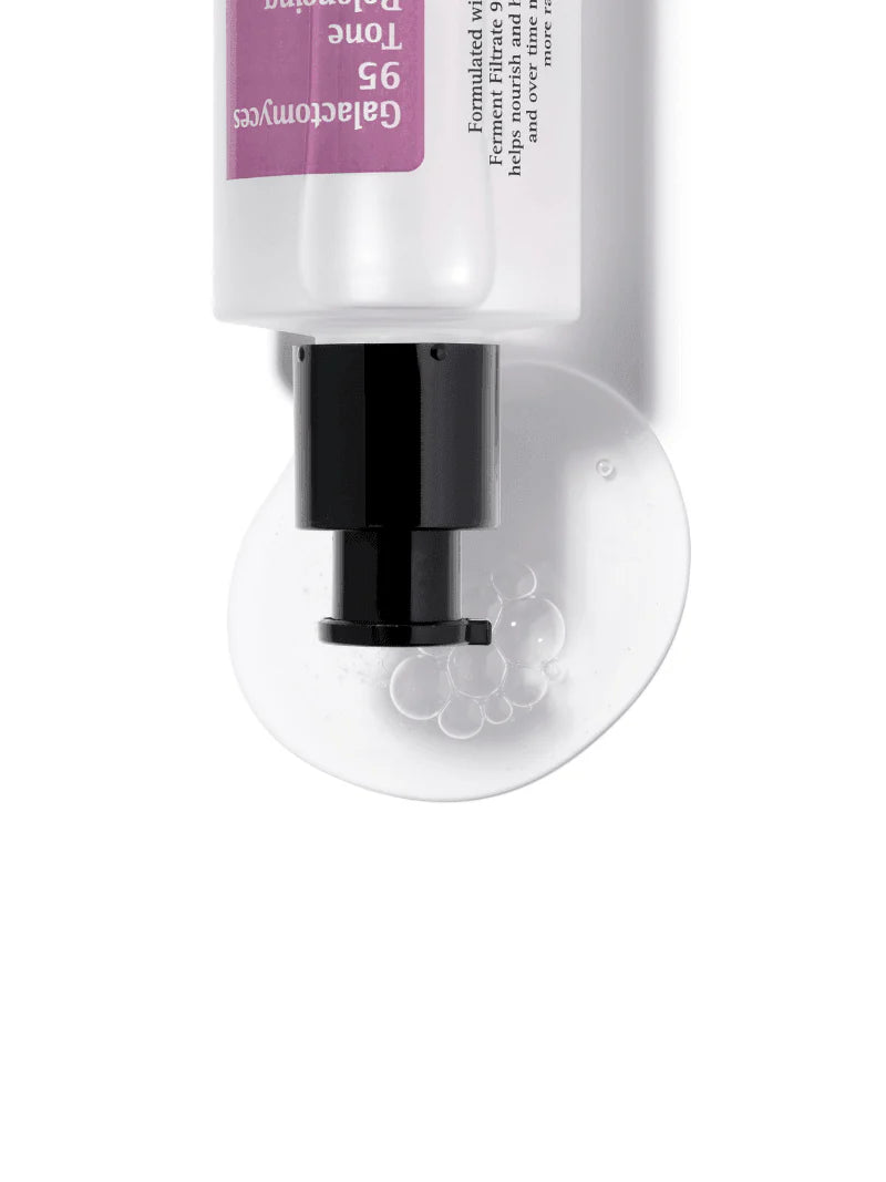 Cosrx Galactomyces 95 Tone Balancing Essence dispensing its gel-like texture with bubbles onto a smooth surface.