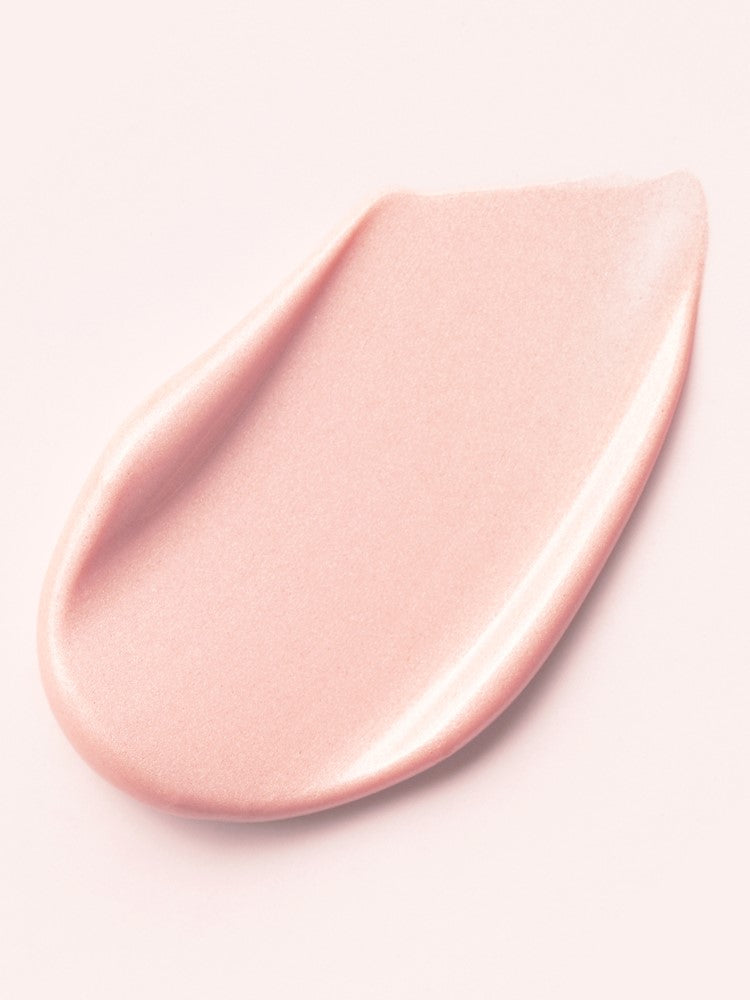 A smooth, glowing pink cream of d'Alba Waterfull Tone-Up Sunscreen swirled on a light background, highlighting its texture that corrects redness, delivers a tone-up effect, and doubles as a primer.