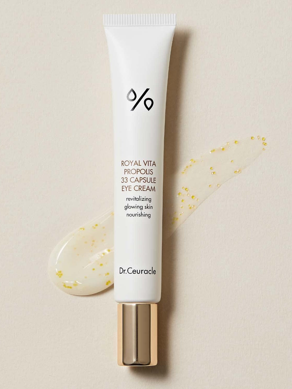 A tube of Dr. Ceuracle Royal Vita Propolis 33 Capsule Eye Cream, showcasing its glossy texture with golden Propolis beads for radiant, anti-aging benefits.