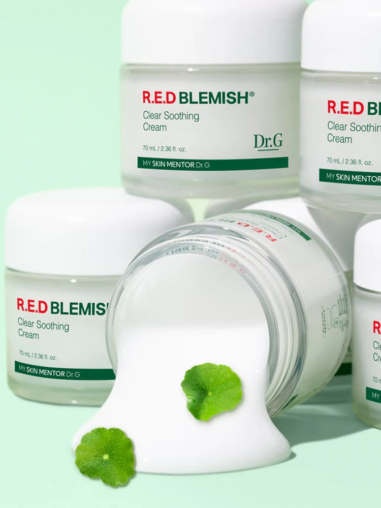 Five jars of Dr.G Red Blemish Cica Soothing Cream on a mint background, with one tipped over to reveal the creamy texture alongside Centella Asiatica leaves, emphasizing its soothing CICA ingredients.