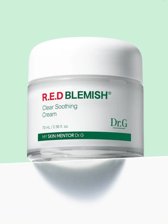 A jar of Dr.G Red Blemish Cica Soothing Cream on a mint background, featuring its clean, minimalist packaging design.