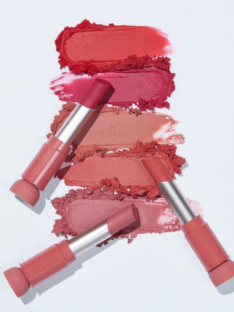 Flat lay of five Etude House Fixing Tint Bar lipsticks in various pink and red shades, with swatches of each color displayed on a white background.