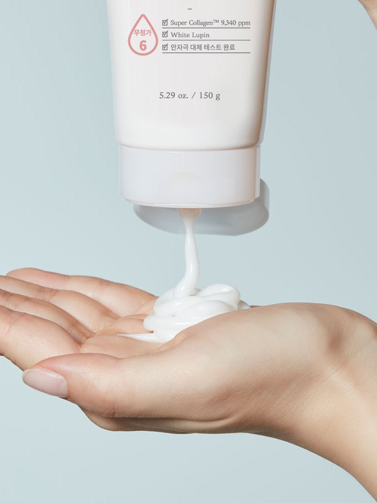 A hand holds a dollop of Etude House Moistfull Collagen Cleansing Foam, showcasing its creamy texture against a light background.