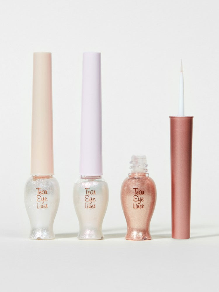Three bottles of Etude House Tear Eye Liner in different shades, with two closed and one open displaying its brush, arranged against a plain background.