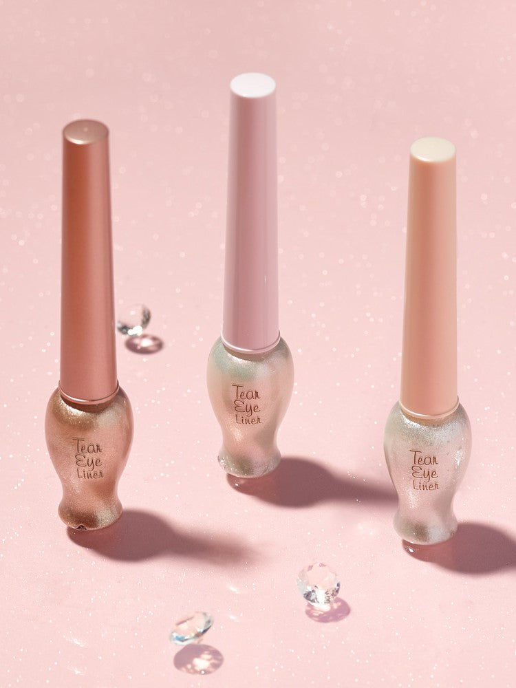 Etude House Tear Eye Liners in sleek bottles displayed on a sparkling pink background, adorned with scattered diamond-like gems.