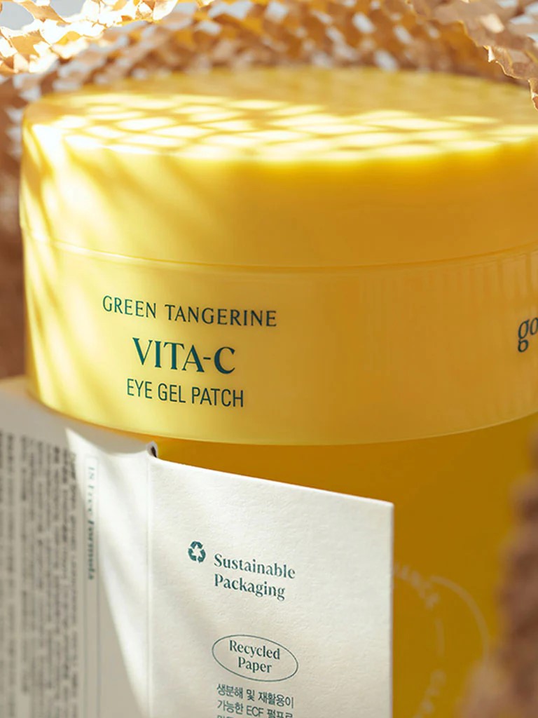 A vibrant yellow jar of Goodal Green Tangerine Vita C Eye Gel Patch, emphasizing its eco-friendly packaging and sleek design.