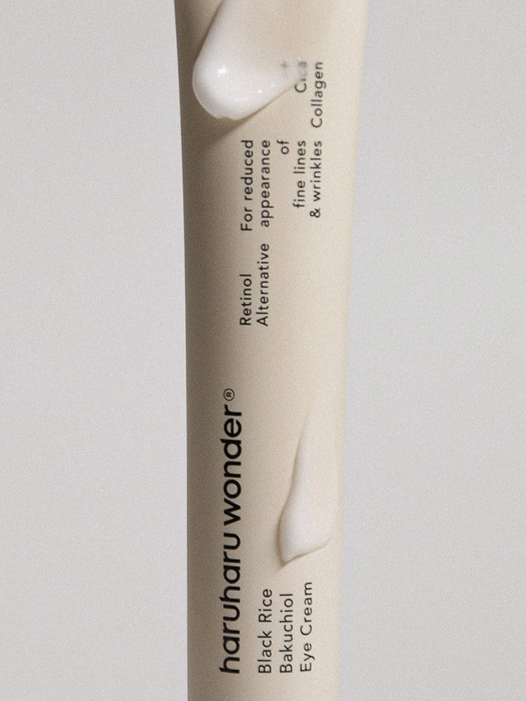 Close-up of Haruharu Wonder Black Rice Bakuchiol Eye Cream tube showing its smooth texture, highlighting key ingredients Black Rice and Bakuchiol, formulated to reduce fine lines and wrinkles.