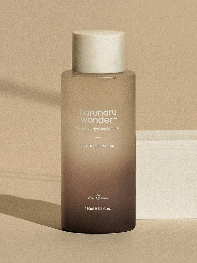 A sleek bottle of Haruharu Wonder Black Rice Hyaluronic Toner on a neutral background, showcasing its minimalist design and branding.