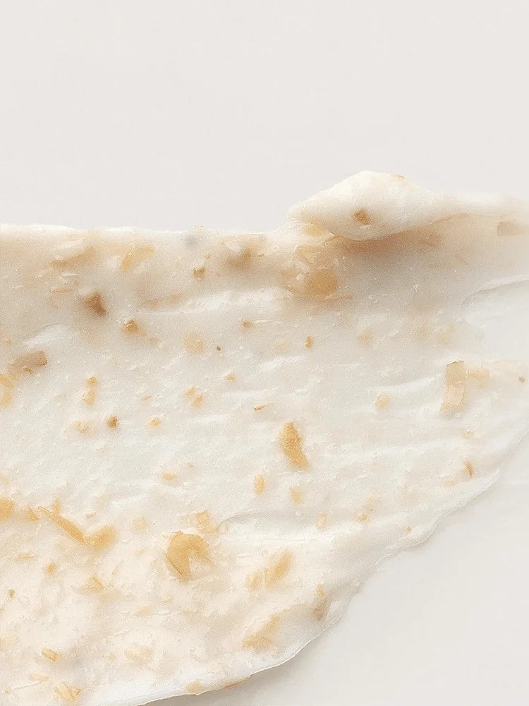 Close-up of the creamy white texture of the 'I'm From' Rice Mask, flecked with small rice hull particles for gentle exfoliation.