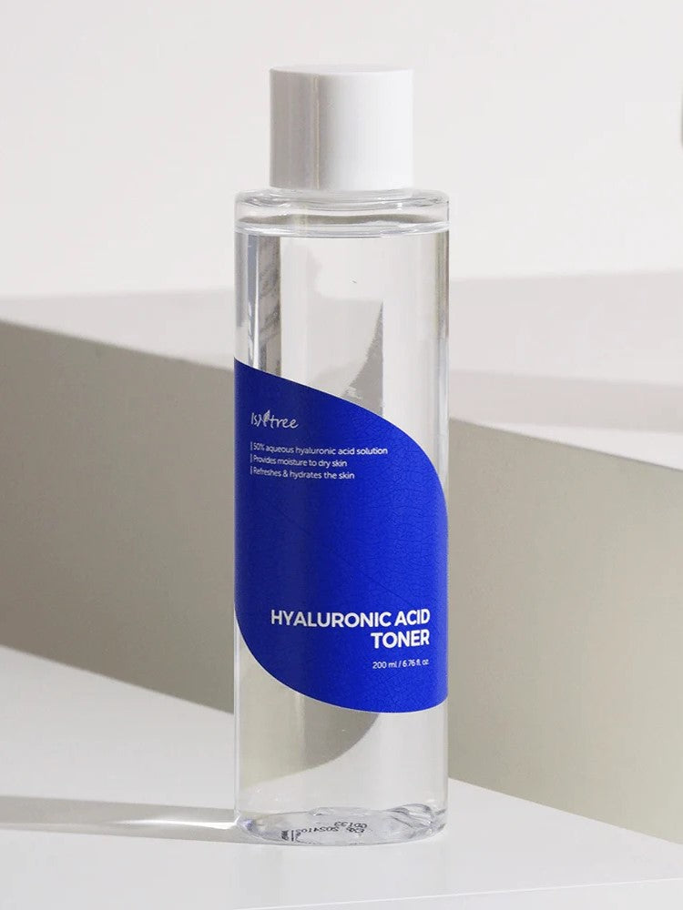 Clear bottle of Isntree Hyaluronic Acid Toner with a blue label, designed to provide deep hydration for all skin types; 200 ml size on a light background.