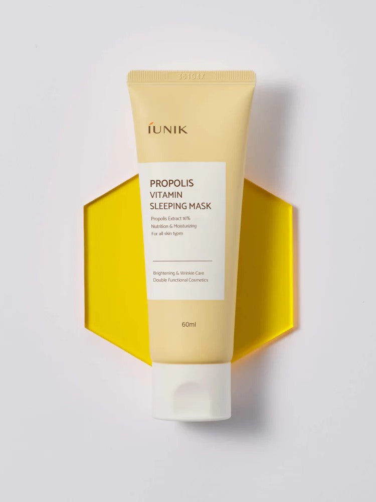 Tube of IUNIK Propolis Vitamin Sleeping Mask placed on a yellow hexagon background, highlighting its nourishing and moisturizing benefits with a vibrant design.