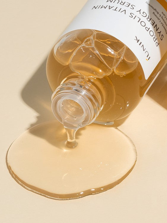 Close-up of iUNIK Propolis Vitamin Synergy Serum’s rich golden texture, showcasing nourishing and brightening properties for radiant skin.