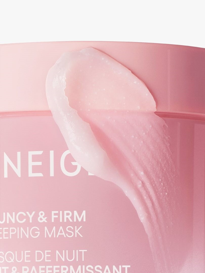 Close-up of Laneige Bouncy & Firm Sleeping Mask showing creamy light pink texture spread beside the jar on a white background.