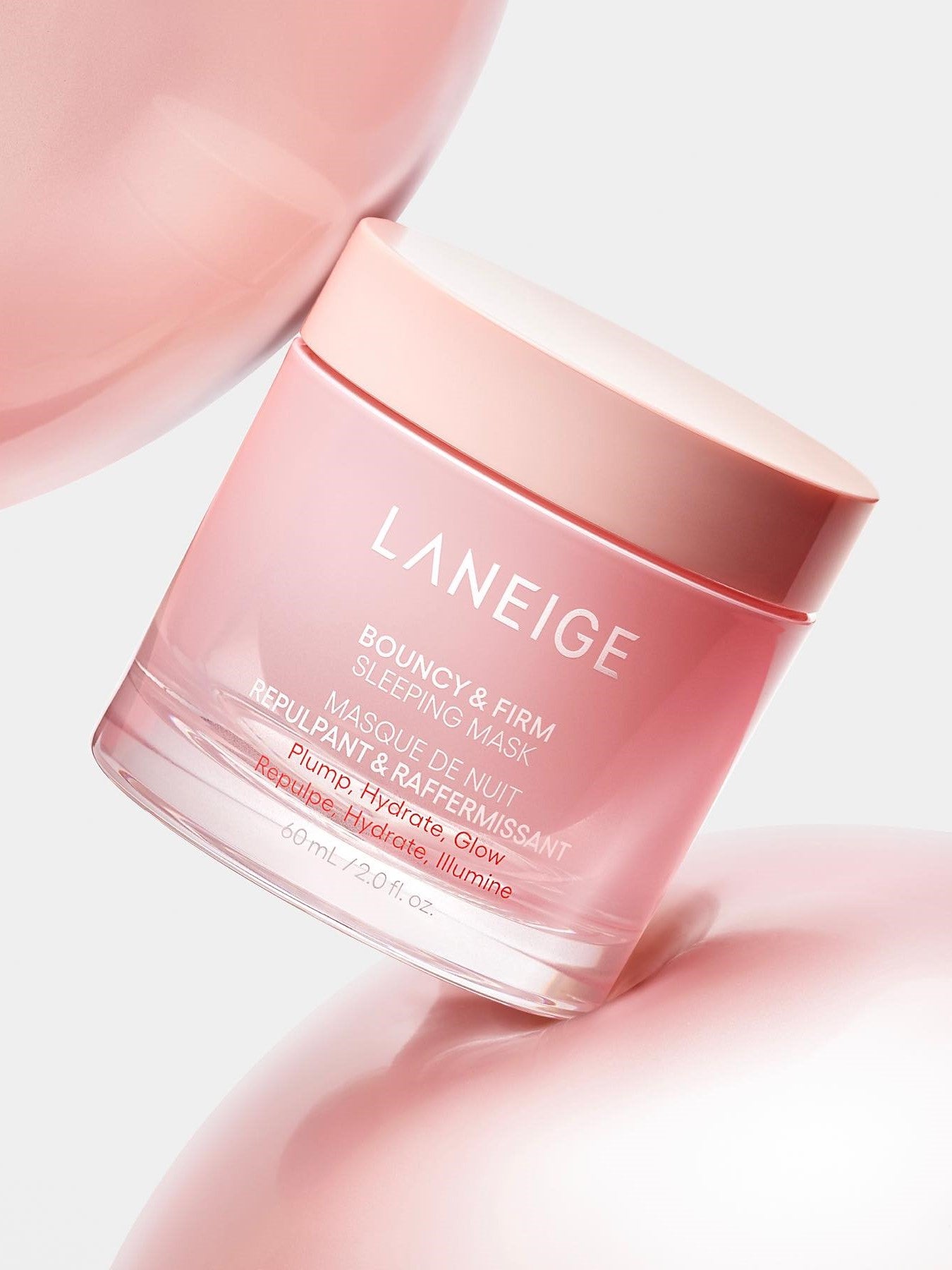 Pink jar of Laneige Bouncy & Firm Sleeping Mask, labeled in English and French, highlighting hydration and plumping, on a pink background.