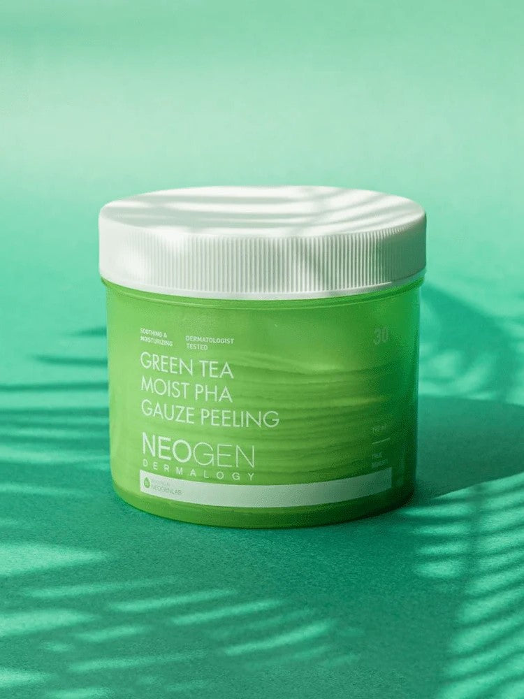 Green jar labeled 'Neogen Dermalogy Green Tea Moist PHA Gauze Peeling' displayed against a vibrant green background with soft shadows, highlighting its exfoliating and hydrating properties.