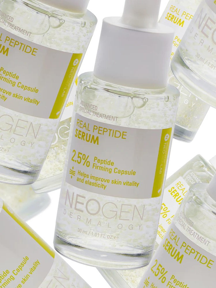 Close-up of Neogen Real Peptide Serum bottles containing clear liquid, featuring a yellow label highlighting 2.5% peptide for firming benefits.