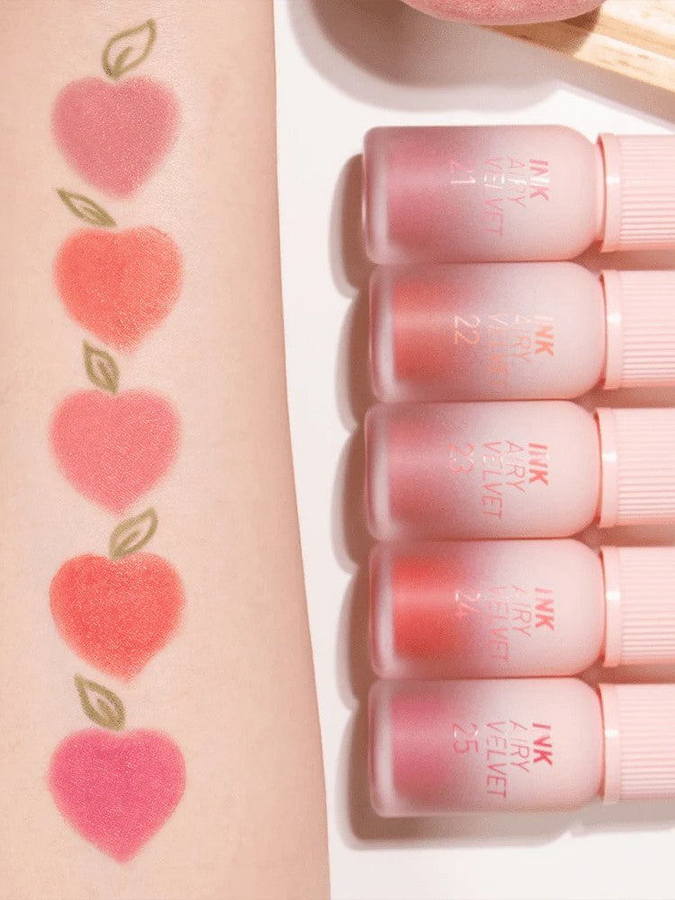 Swatches of peachy lip colors from Peripera INK Airy Velvet lip tint Peaches Collection on an arm, with matching tubes showing texture.