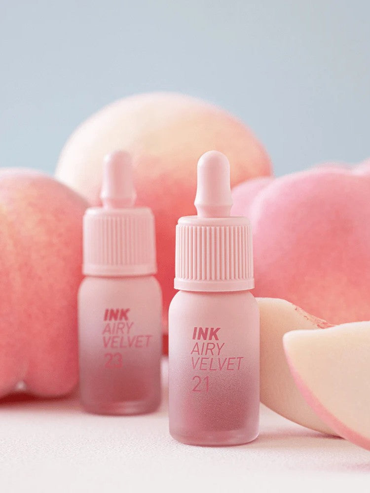 Peripera INK AIRY VELVET 21 and 23 Peaches Collection lip tints displayed amidst soft peach-like backgrounds and slices.