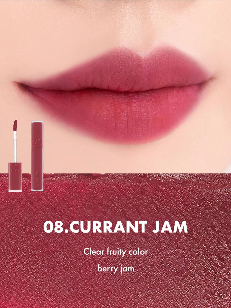 Close-up of lips wearing Romand Blur Fudge Tint in the shade Currant Jam.