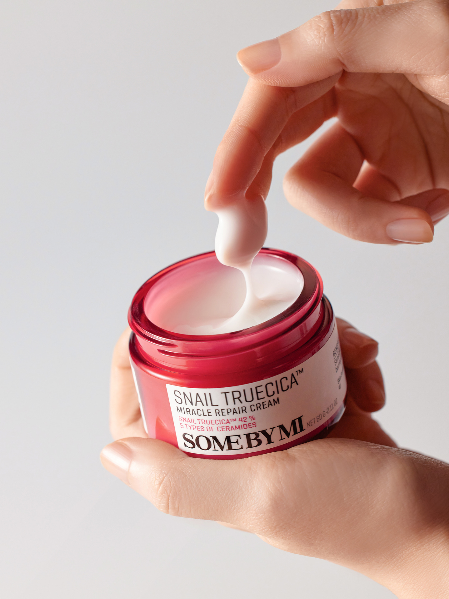 some by mi snail truecica miracle repair cream texture with hands