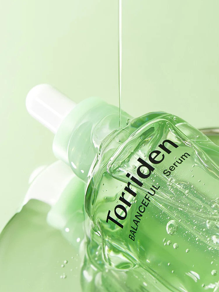 "Torriden Balanceful Serum with lightweight formula dripping from the dropper.