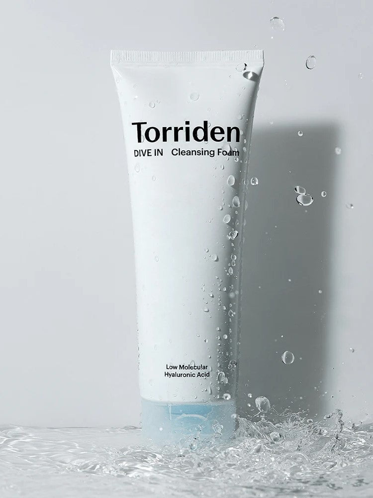 White tube of Torriden DIVE IN Cleansing Foam with water droplets, labeled 'Low Molecular Hyaluronic Acid.