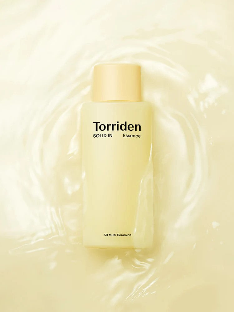 Yellow bottle of Torriden Solid IN Essence with light yellow cap, surrounded by water, highlighting its 5D Multi Ceramide formula.
