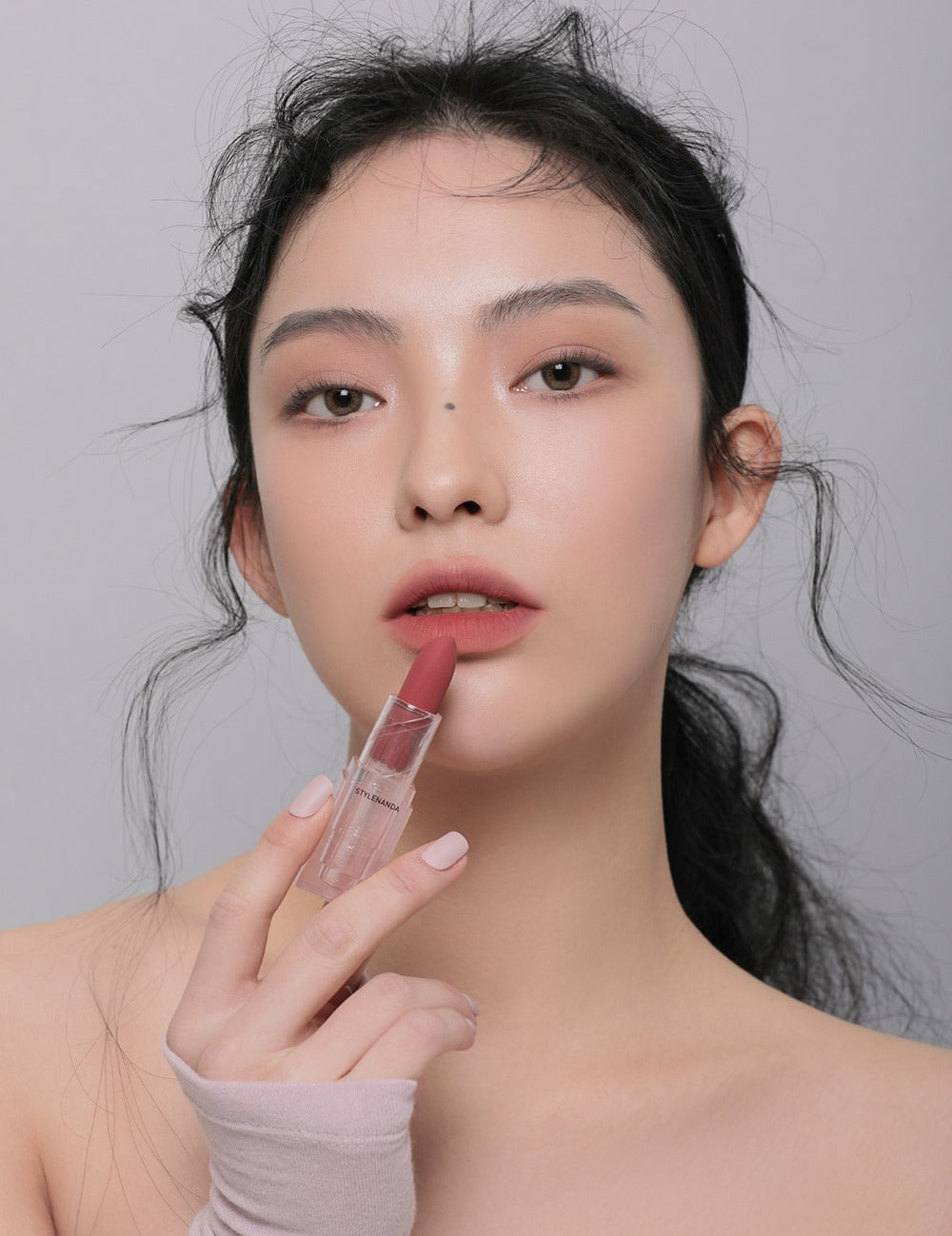 Model applying 3CE Soft Matte Lipstick in Shade Chill Move, showcasing its velvety texture and smooth matte finish.