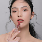 Model applying 3CE Soft Matte Lipstick in Shade Chill Move, showcasing its velvety texture and smooth matte finish.