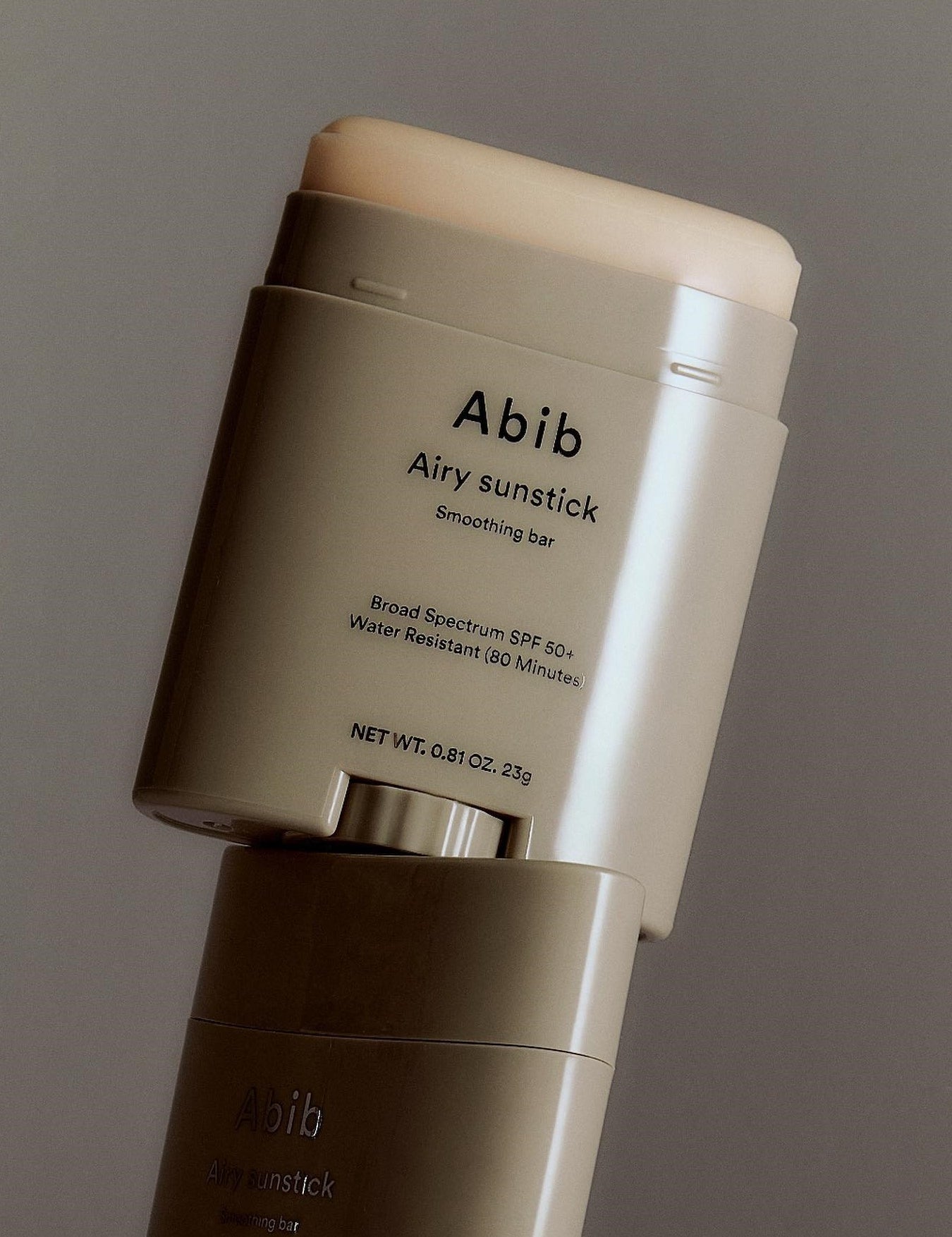 Close-up of the Abib Airy Sunstick, a waterproof SPF 50+ sunscreen stick in sleek taupe packaging designed for easy application.