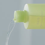 Close-up of Abib Heartleaf Calming Toner bottle pouring its lightweight, watery texture against a soft neutral background.