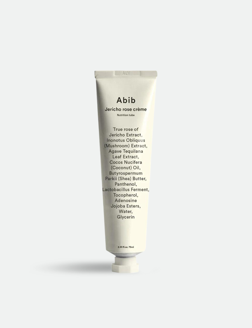 A white tube of Abib Jericho Rose Crème, showcasing ingredient details and minimalist branding, displayed against a light gray background.