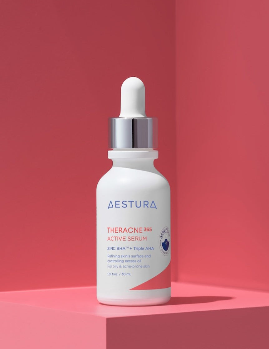 Aestura Theracne 365 Active Serum bottle on a soft pink background, formulated for oily and acne-prone skin with refining ingredients.