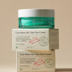 Jar of AXIS-Y Cera-Heart My Type Duo Cream atop two boxes, highlighting moisturizing benefits for diverse skin types.