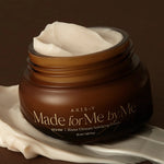 AXIS-Y 'Made for Me by Me' Biome Ultimate Indulging Cream with creamy texture, placed on a dark smooth surface.