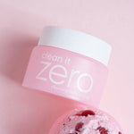 Banila Co Clean It Zero Cleansing Balm Original placed next to a scoop of acerola berry ice cream on a pink background, referencing its key ingredient Acerola Berry.