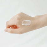 A hand resting on a white background with a small dollop of Beauty of Joseon Apricot Blossom Peeling Gel, highlighting its smooth and lightweight texture.