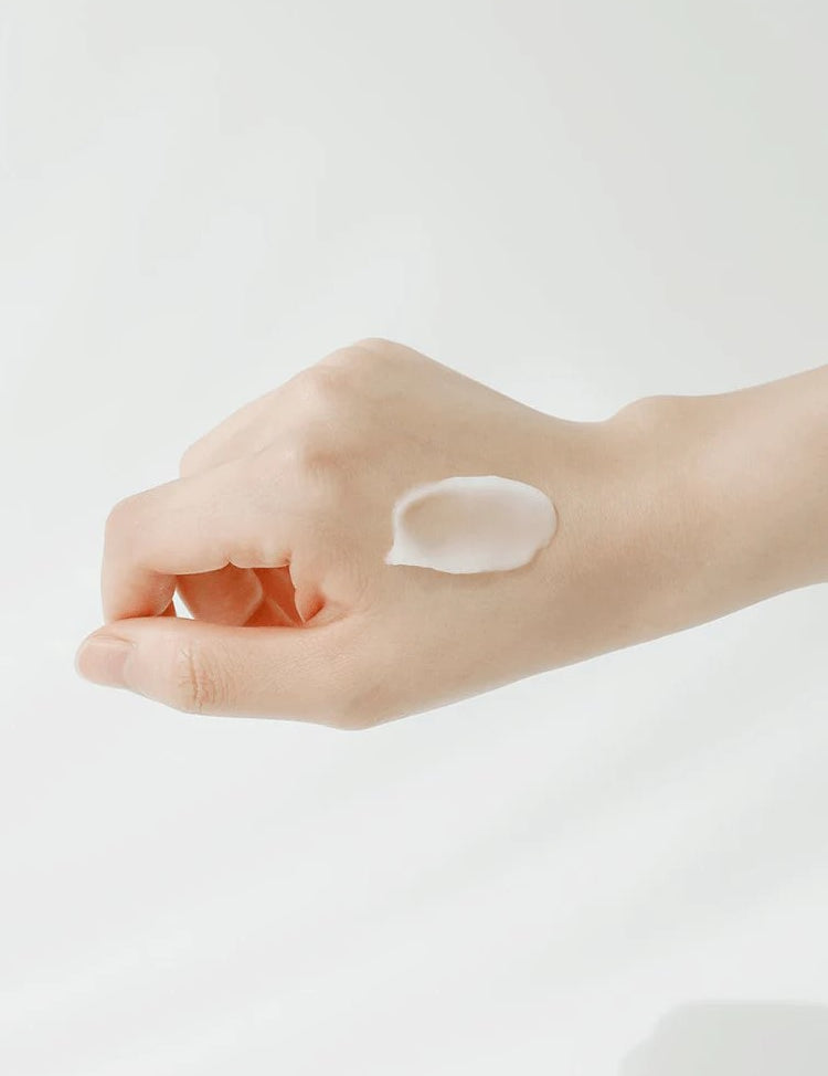 A hand resting on a white background with a small dollop of Beauty of Joseon Apricot Blossom Peeling Gel, highlighting its smooth and lightweight texture.